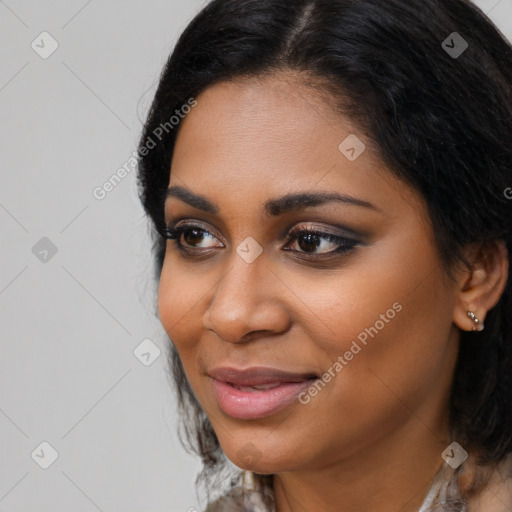 Joyful black young-adult female with medium  black hair and brown eyes