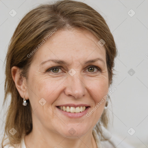 Joyful white adult female with medium  brown hair and brown eyes