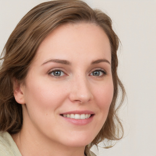 Joyful white young-adult female with medium  brown hair and blue eyes