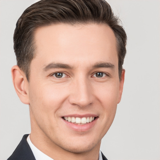 Joyful white young-adult male with short  brown hair and brown eyes