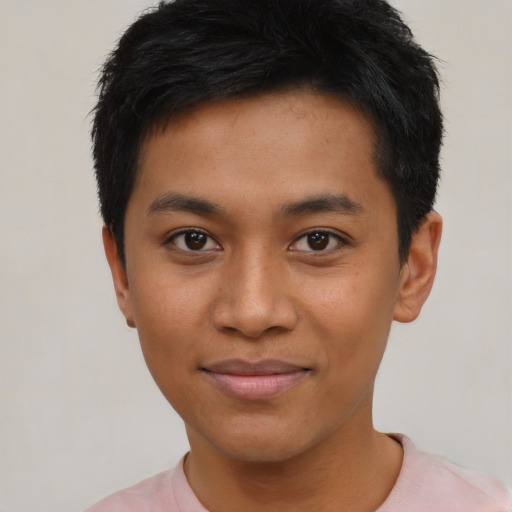 Joyful asian young-adult male with short  black hair and brown eyes