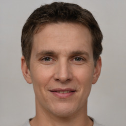 Joyful white adult male with short  brown hair and brown eyes