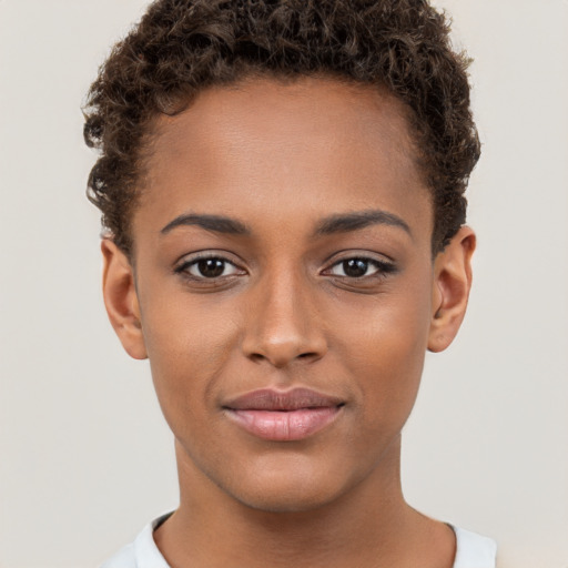 Joyful black young-adult female with short  brown hair and brown eyes