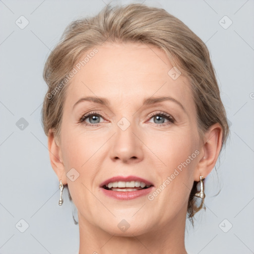 Joyful white adult female with medium  brown hair and grey eyes