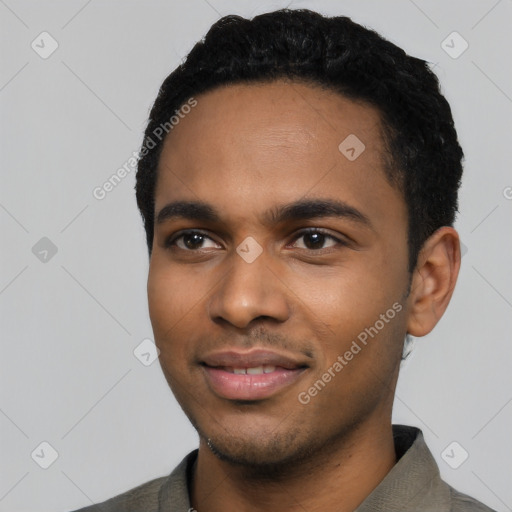 Joyful black young-adult male with short  black hair and brown eyes