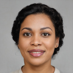 Joyful latino young-adult female with medium  black hair and brown eyes