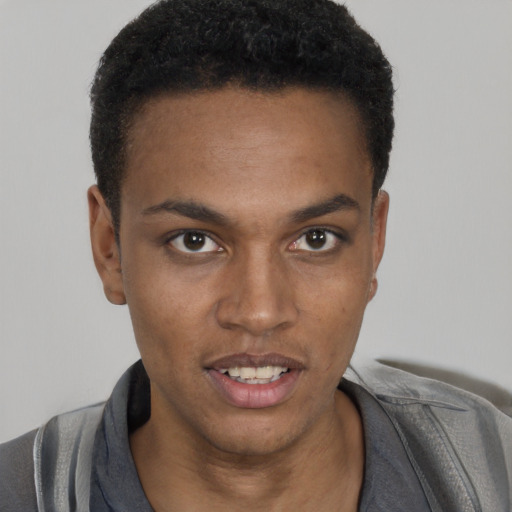 Joyful black young-adult male with short  black hair and brown eyes