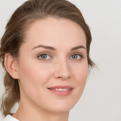 Joyful white young-adult female with medium  brown hair and green eyes