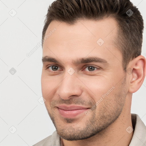 Joyful white young-adult male with short  brown hair and brown eyes