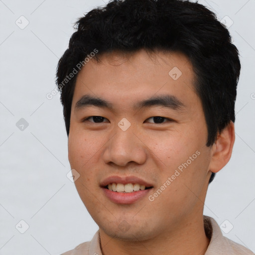 Joyful asian young-adult male with short  black hair and brown eyes