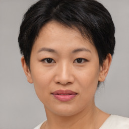 Joyful asian young-adult female with short  brown hair and brown eyes