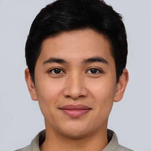 Joyful asian young-adult male with short  black hair and brown eyes