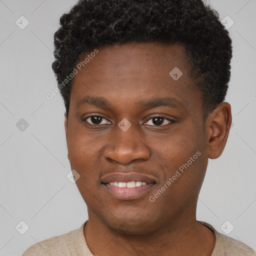 Joyful black young-adult male with short  brown hair and brown eyes