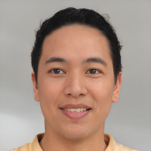 Joyful latino young-adult male with short  brown hair and brown eyes