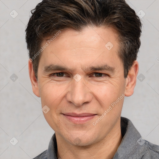 Joyful white adult male with short  brown hair and brown eyes