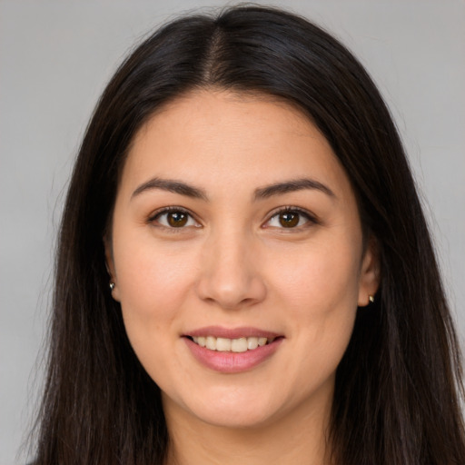 Joyful white young-adult female with long  brown hair and brown eyes