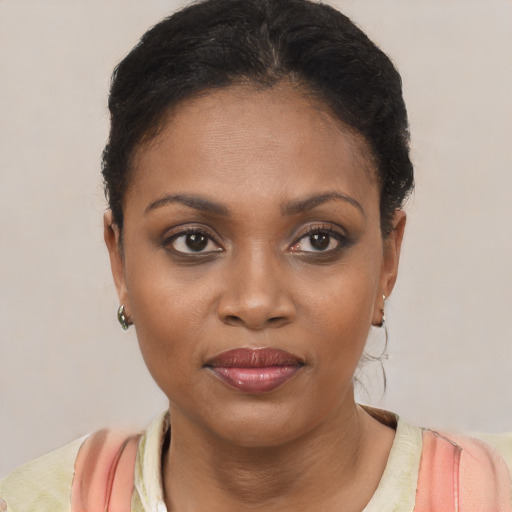 Joyful black young-adult female with short  brown hair and brown eyes