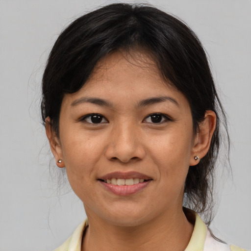 Joyful asian adult female with medium  brown hair and brown eyes