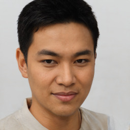 Joyful asian young-adult male with short  brown hair and brown eyes