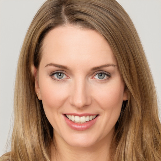 Joyful white young-adult female with long  brown hair and green eyes