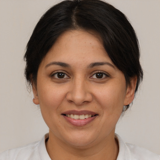 Joyful white adult female with medium  brown hair and brown eyes