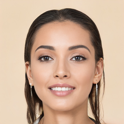 Joyful white young-adult female with long  brown hair and brown eyes