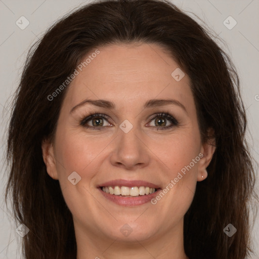 Joyful white adult female with long  brown hair and brown eyes