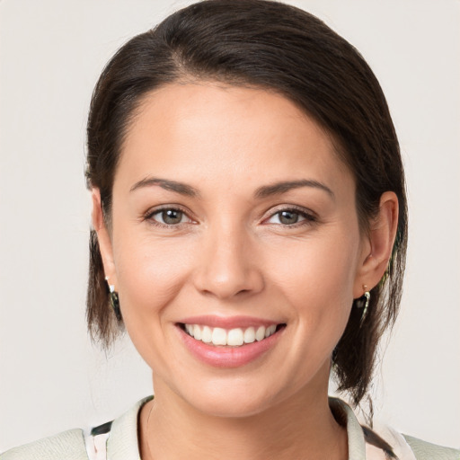 Joyful white young-adult female with medium  brown hair and brown eyes