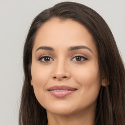 Joyful latino young-adult female with long  brown hair and brown eyes