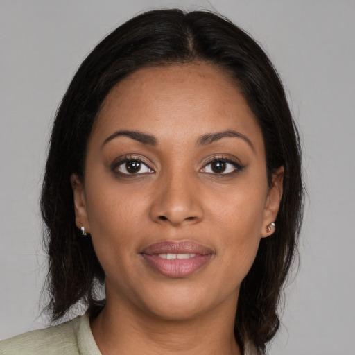 Joyful black young-adult female with medium  brown hair and brown eyes