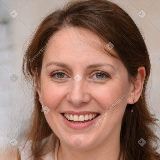 Joyful white adult female with medium  brown hair and grey eyes