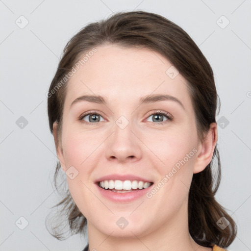 Joyful white young-adult female with medium  brown hair and grey eyes