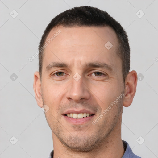 Joyful white adult male with short  brown hair and brown eyes