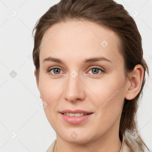 Joyful white young-adult female with long  brown hair and grey eyes