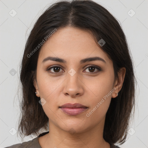 Joyful latino young-adult female with medium  brown hair and brown eyes