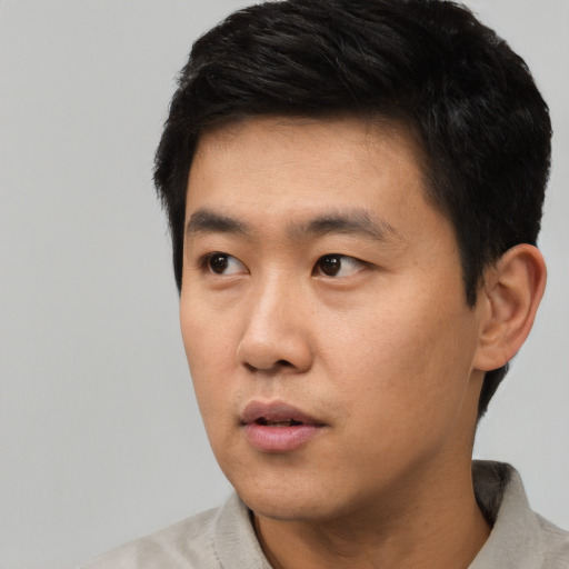 Neutral asian young-adult male with short  black hair and brown eyes
