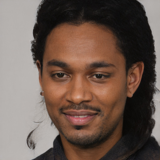 Joyful black young-adult male with short  black hair and brown eyes