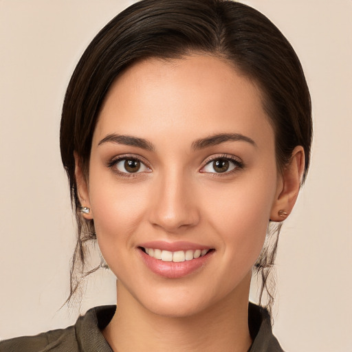 Joyful white young-adult female with long  brown hair and brown eyes