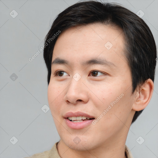 Joyful asian young-adult male with short  brown hair and brown eyes
