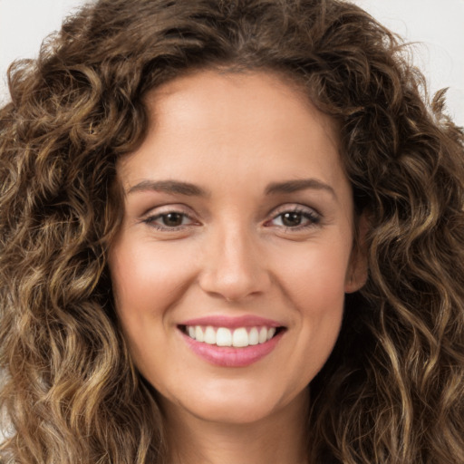 Joyful white young-adult female with long  brown hair and green eyes