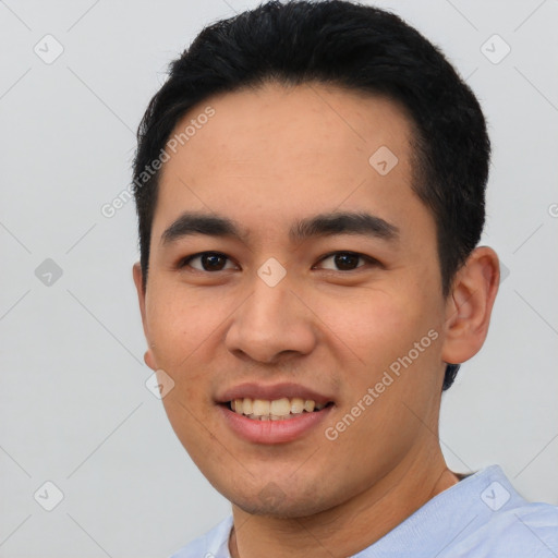 Joyful asian young-adult male with short  black hair and brown eyes