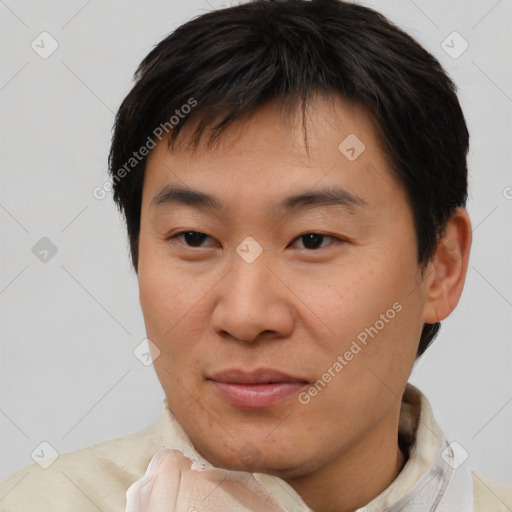 Joyful asian young-adult male with short  brown hair and brown eyes