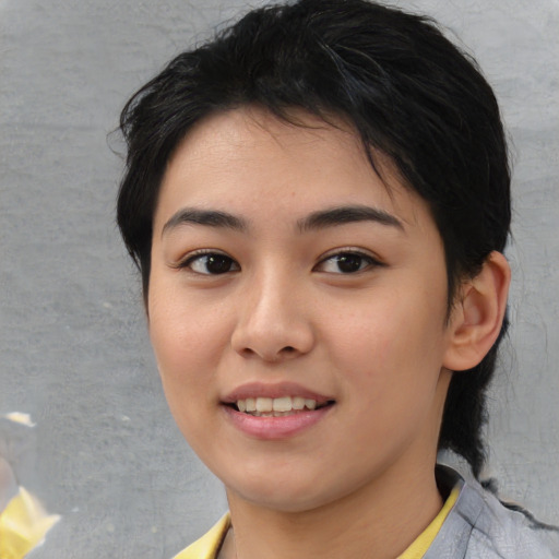 Joyful asian young-adult female with medium  black hair and brown eyes