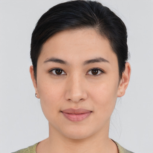 Joyful asian young-adult female with medium  brown hair and brown eyes
