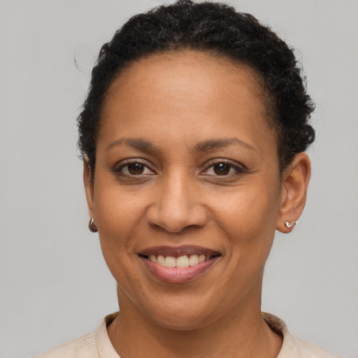 Joyful latino adult female with short  brown hair and brown eyes