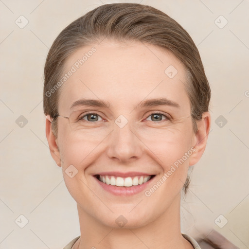 Joyful white young-adult female with short  brown hair and grey eyes