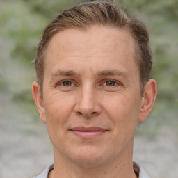 Joyful white adult male with short  brown hair and brown eyes