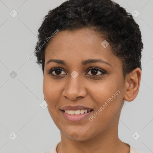 Joyful black young-adult female with short  brown hair and brown eyes