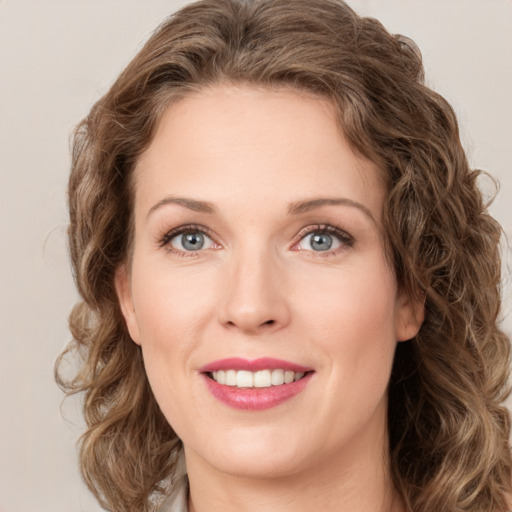 Joyful white young-adult female with medium  brown hair and green eyes