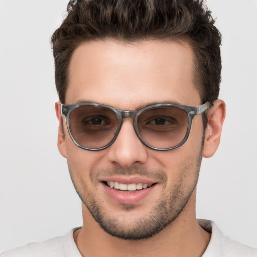 Joyful white young-adult male with short  brown hair and brown eyes